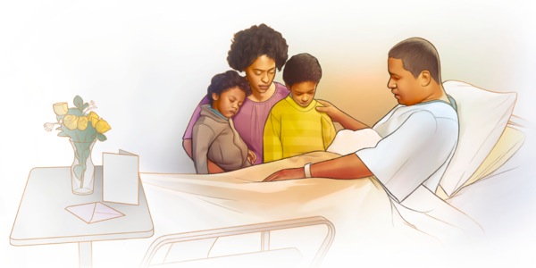 A man in a hospital bed prays with his family