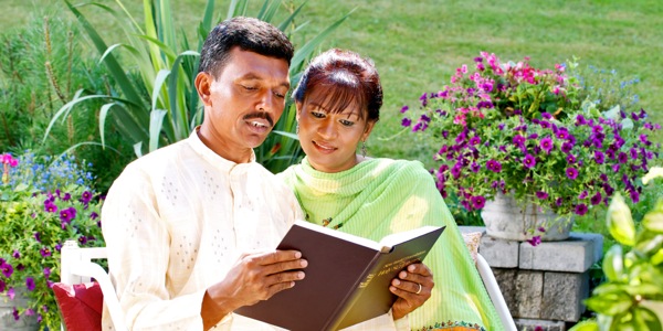 A married couple reading the Bible together