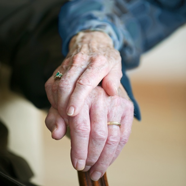 An older married couple holding hands