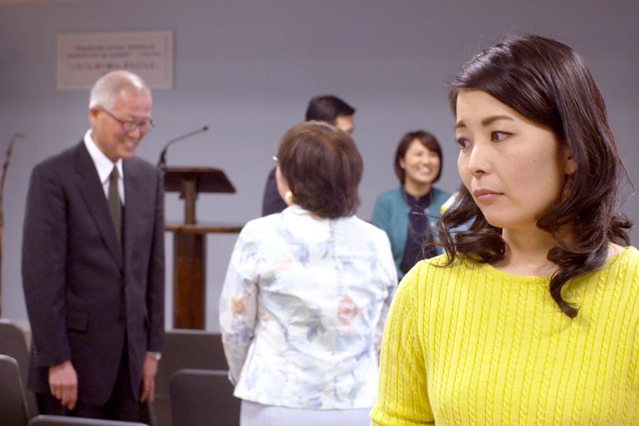 Miki is irritated by others in the congregation