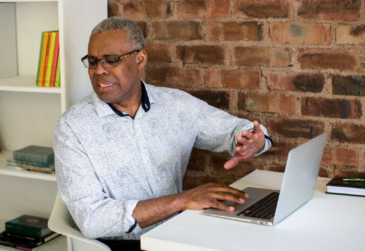 A brother turns away from his computer screen