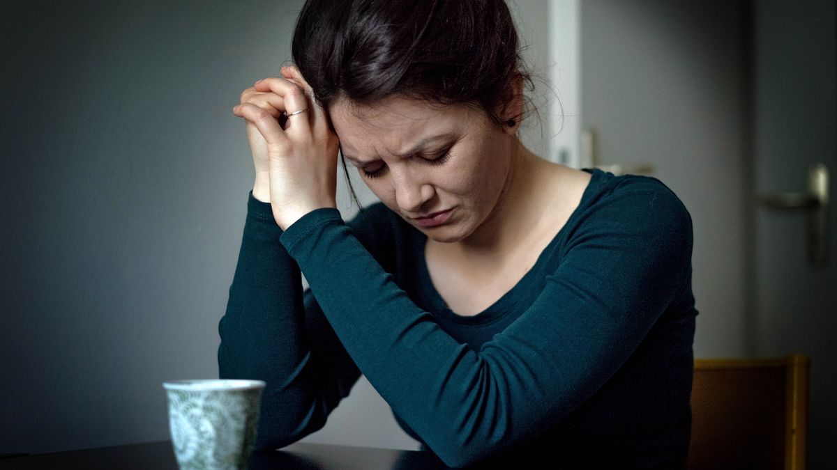 A distressed sister praying fervently.