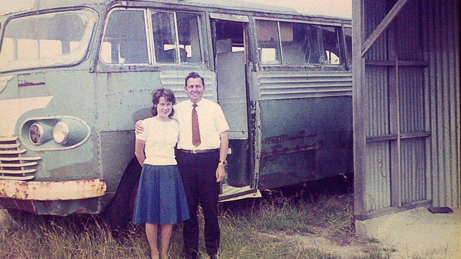 Winston and Pam Payne stand beside a bus, one of their accommodations while in circuit work