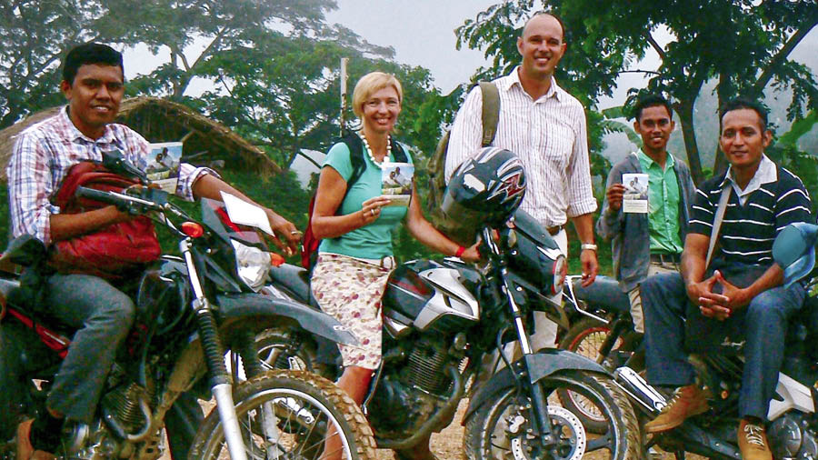 Vanessa, Alex, and three local brothers using motorbikes to travel and distribute Memorial invitations.