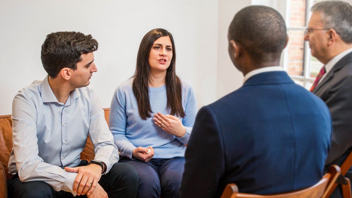 The sister shown earlier expressing herself while her husband and two elders listen intently.