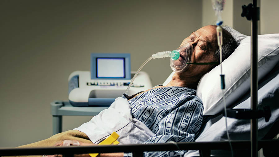 A sick man in a hospital bed.