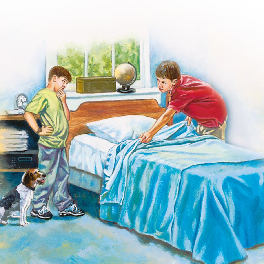 An older boy helps his younger brother make his bed