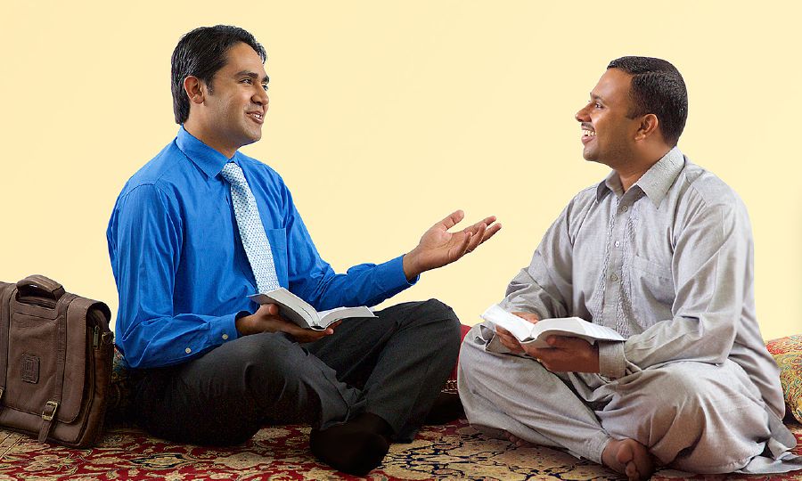 Ein Zeuge Jehovas bespricht mit einem Mann etwas aus der Bibel