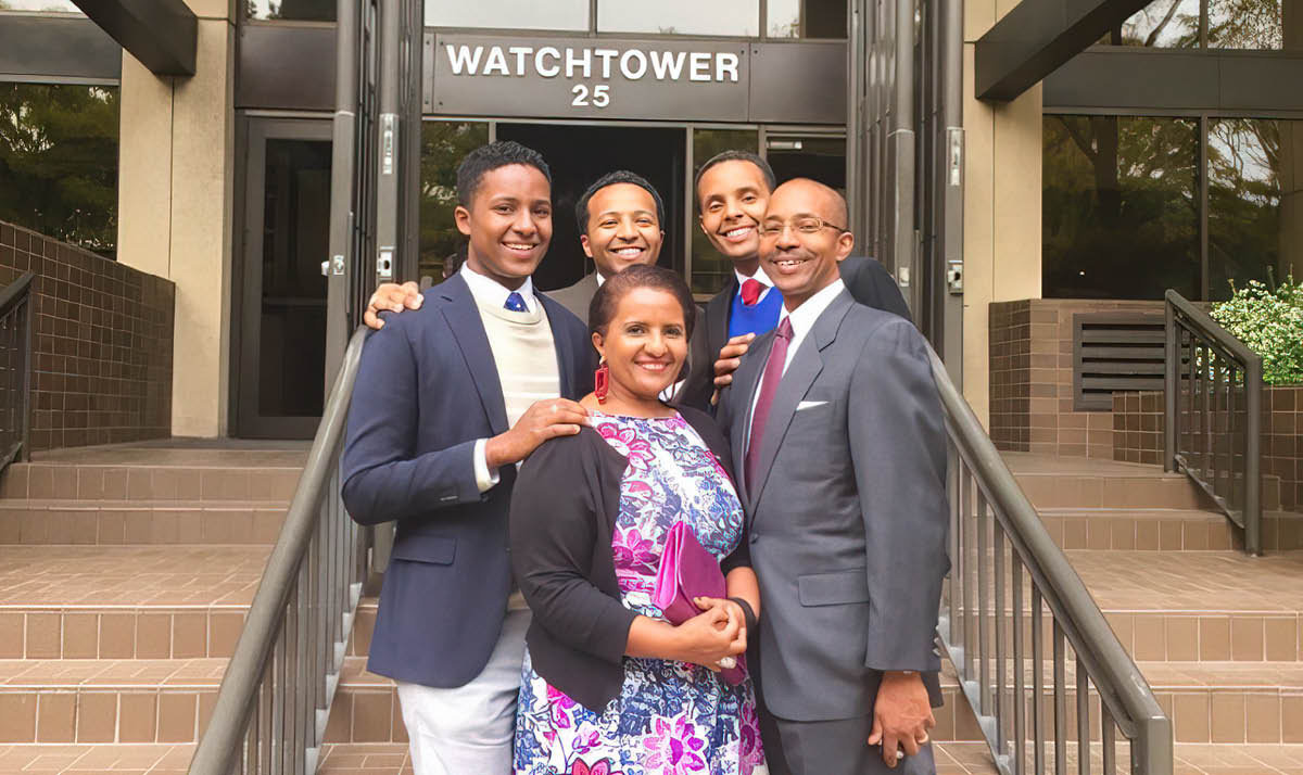 แอสเธอร์​กับ​เวสลีย์ สามี​ของ​เธอ และ​ลูก​ชาย 3 คน​ยืน​ยิ้ม​ถ่าย​รูป​หน้า​ทาง​เข้า​อาคาร​เบเธล​ที่​บรุกลิน