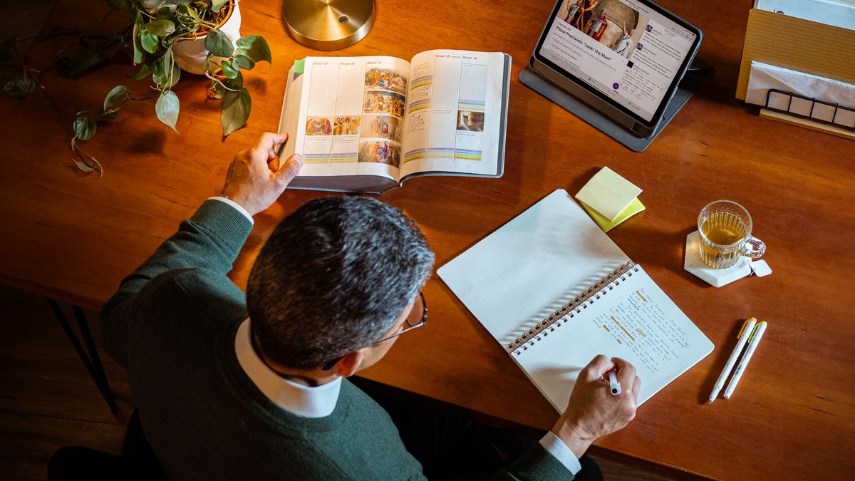 พี่​น้อง​ชาย​สูง​อายุ​กำลัง​ศึกษา​ส่วน​ตัว​โดย​ใช้​แท็บเล็ต คัมภีร์​ไบเบิล และ​สมุด​โน้ต เขา​ดู​ตาราง “เหตุ​การณ์​ใน​สัปดาห์​ที่​พระ​เยซู​ตาย (ส่วน 2)” ใน​ภาค​ผนวก ข12 ของ “คัมภีร์​ไบเบิล​ฉบับ​แปล​โลก​ใหม่” และ​เขา​เปิด​หนังสือ “พระ​เยซู—ทาง​นั้น ความ​จริง ชีวิต” บท 129