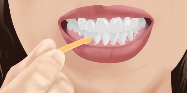 A woman cleaning between her teeth
