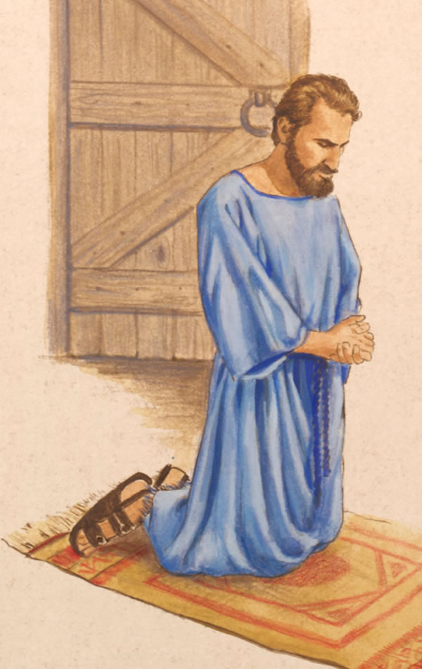 Man i stap wanpis long rum na em i pasim dua na nildaun na beten