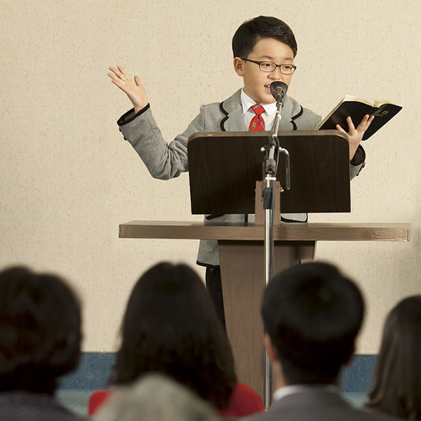 A boy giving a Bible talk at a meeting