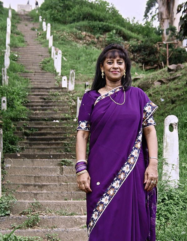 Nalini by the 125 steps leading to her home
