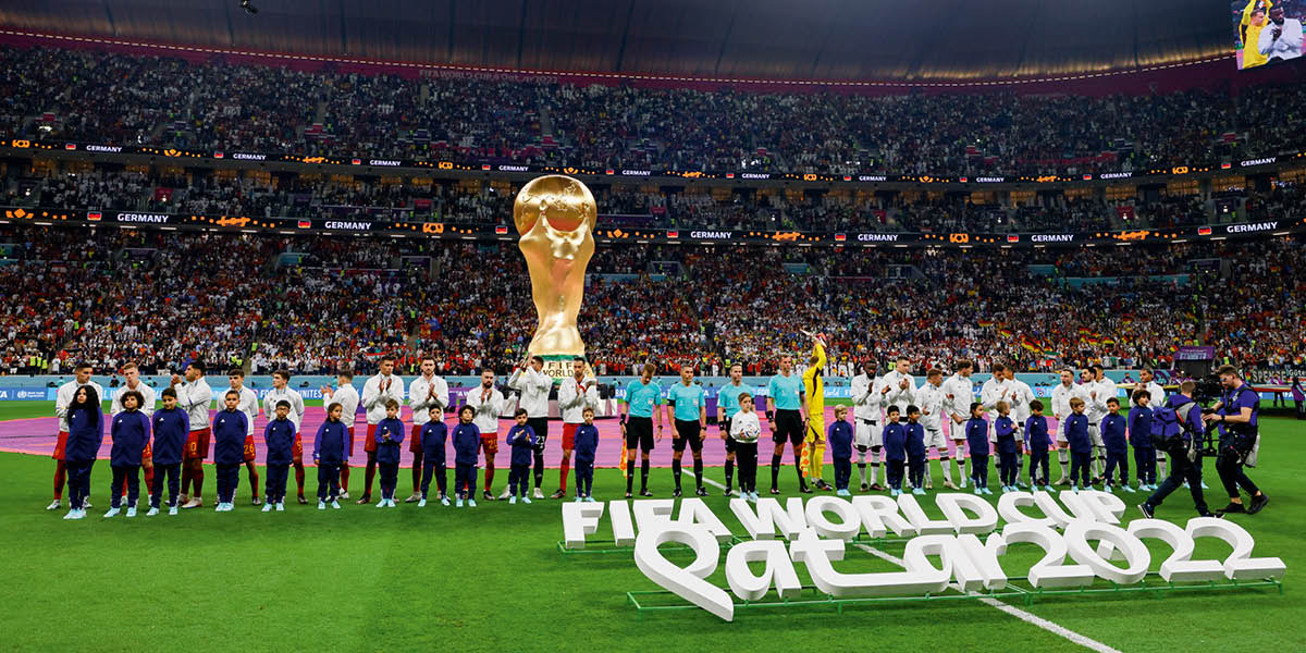 People wey play the World Cup de stand for football field for Qatar.