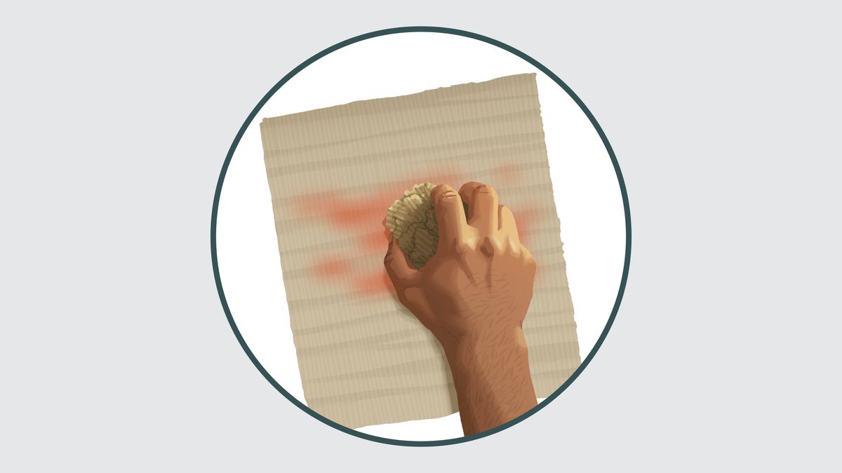 Une main efface avec une éponge ce qui est écrit sur une feuille de papier.