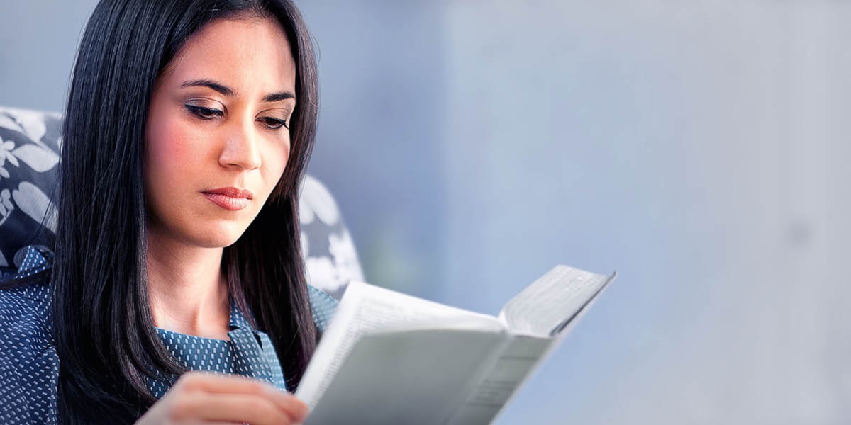 A woman reading the Bible.