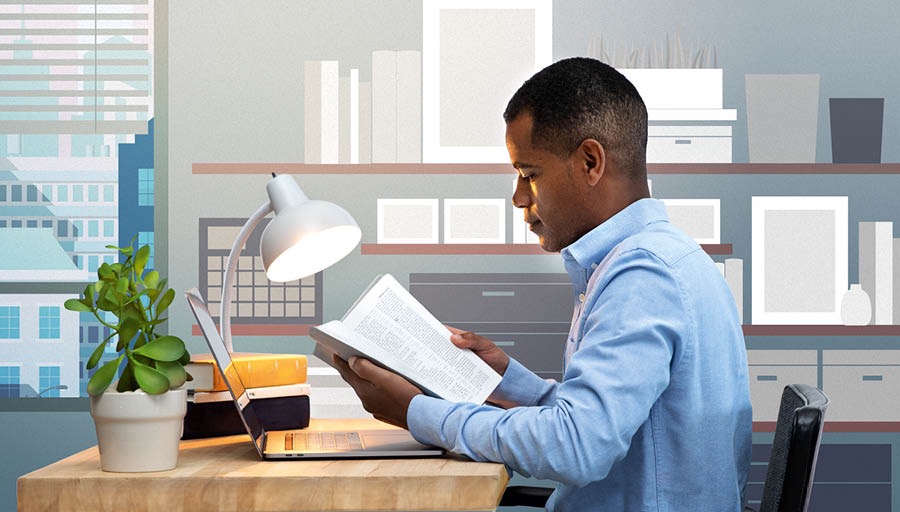 Ngoku le ndoda ifunda iBhayibhile ivule nekhompyutha yayo