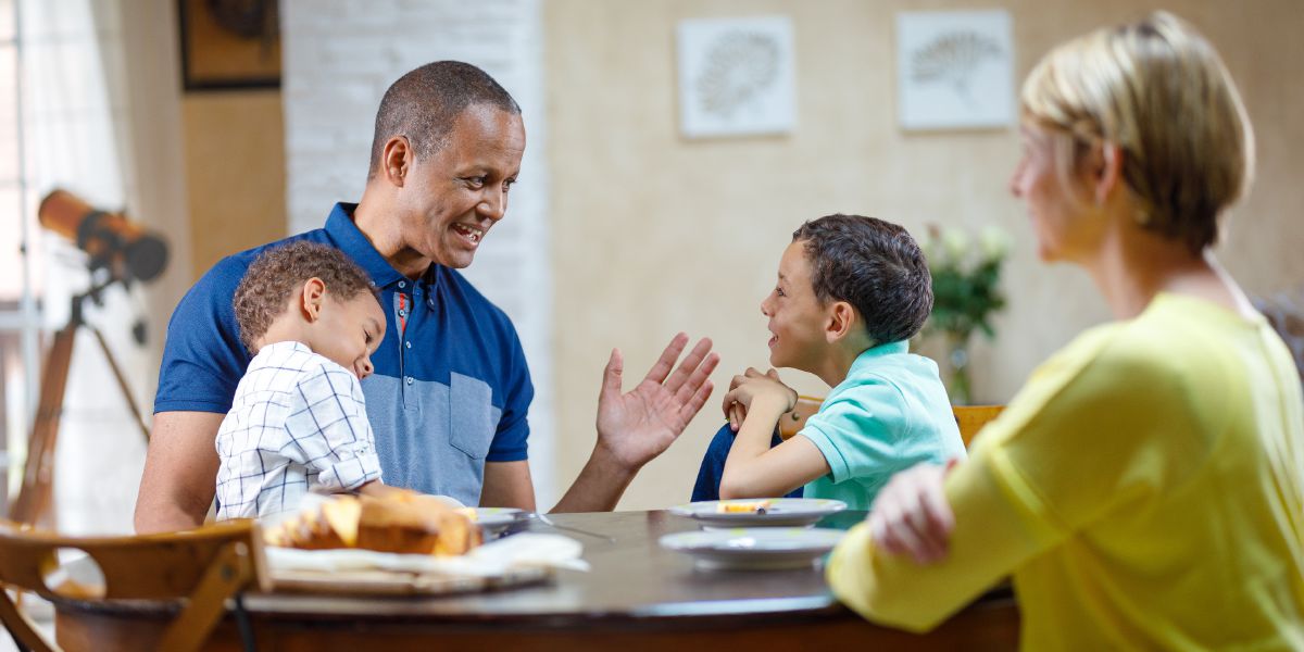 A man talks to his wife and children