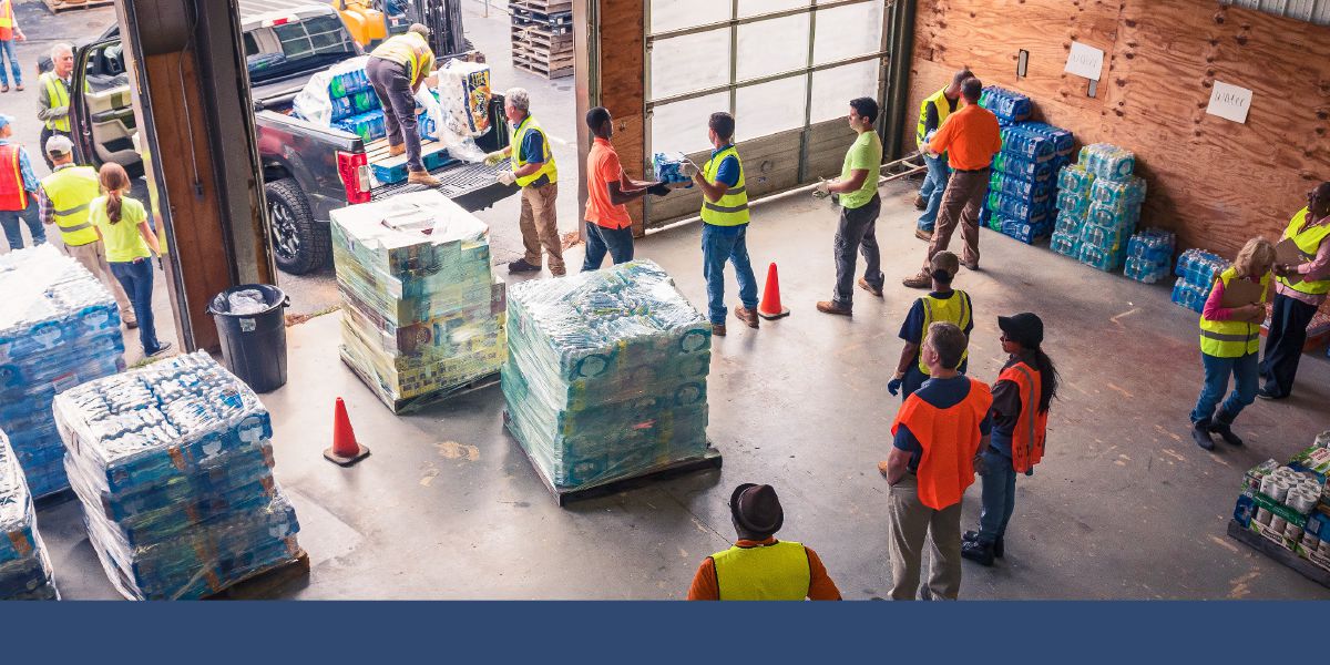 Brothers and sisters unload supplies at a disaster relief center