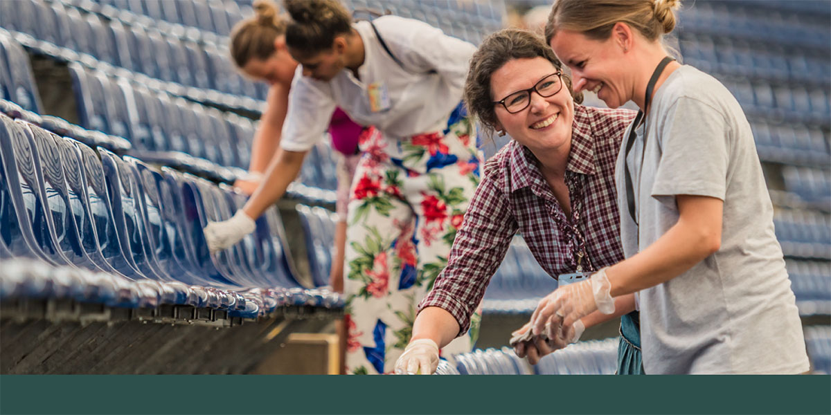 Sisters clean a stadium before a convention in Frankfurt, Germany