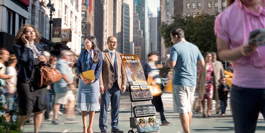 A couple stands beside a literature cart