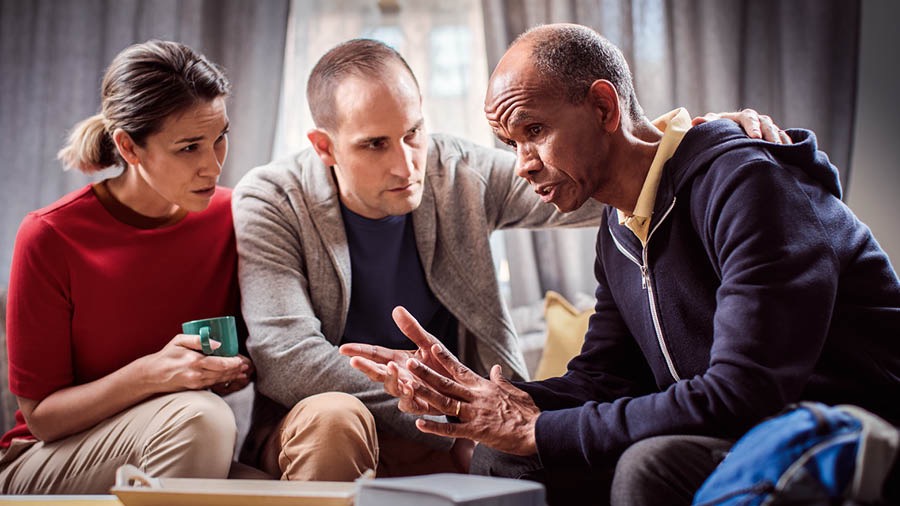 A couple listens to a brother in need