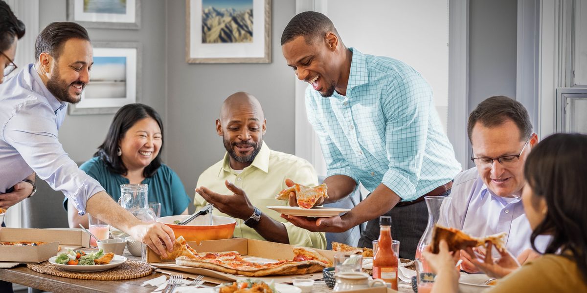 A group of brothers and sisters enjoying a meal together in someone’s home.